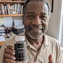 A man holding a bottle of HoneyFil